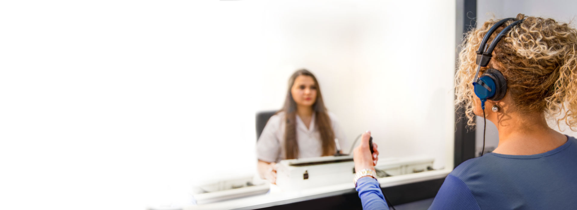 A man at a consultation at a hearing care specialist or an audiologist